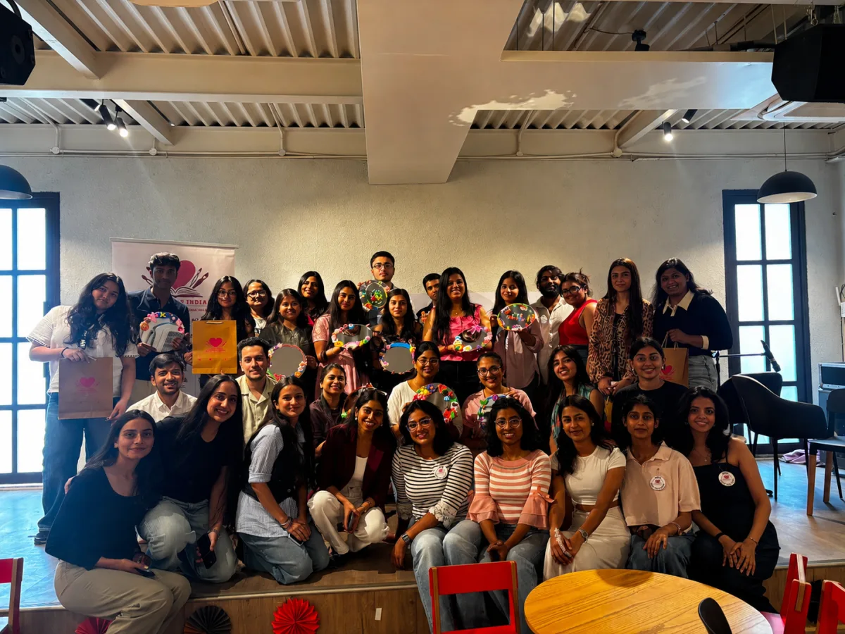 Participants at a Heart Arts India workshop, holding up the hoops and mirrors they decorated.